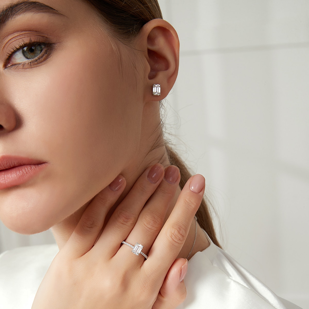 Emerald Cut Moissanite Stud Earrings Hidden Halo (3) Emerald Cut Moissanite Stud Earrings Hidden Halo Modelled